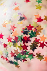 background of colorful confetti stars