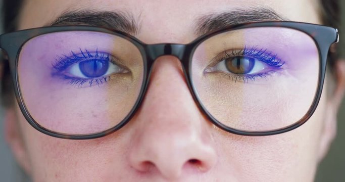 A woman watches with a futuristic look with glasses. augmented reality in holography. 
