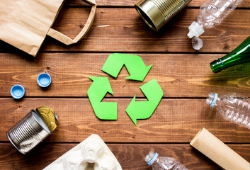environment concept with recycling symbol on wooden background top view