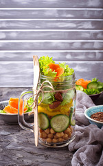Vegetable salad with cucumber, pepper, almond and chick-pea in jar.