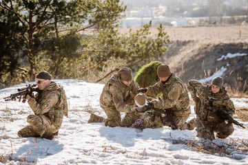 Fototapeta premium soldiers with weapons during the rescue operation. war, army, technology and people concept.