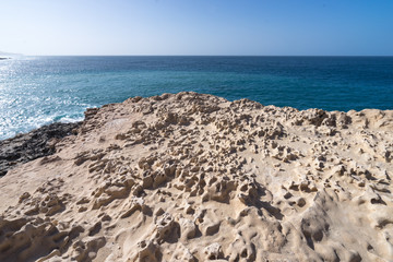 The structure of the volcanic stone on the beach of the Atlantic Ocean