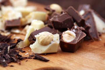 Chocolate bars on a wooden background with chocolate tower