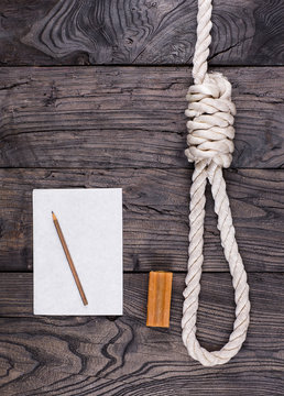 A rope for hanging and a suicide note on an old wooden table,Loop lynch, soap