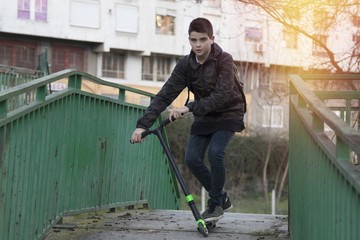 young skating in the city with the scooter