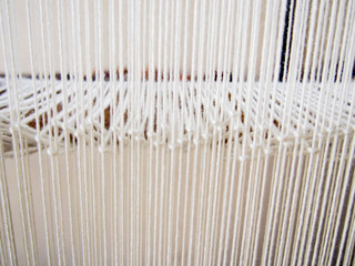 Closeup of Strands of White Yarn on Loom