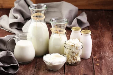 Papier Peint photo Produits laitiers milk products - tasty healthy dairy products on a table on: sour cream in a white bowl, cottage cheese bowl, cream in a a bank and milk jar, glass bottle and in a glass