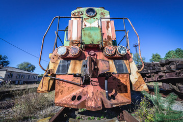 Rusty locomotive on deserted Yaniv railroad station near Pripyat city in Chernobyl Exclusion Zone, Ukraine