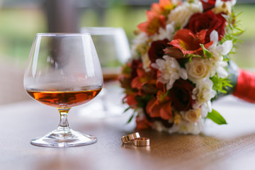 wedding background bouquet and glasses with cognac
