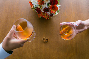wedding background bouquet and glasses with cognac
