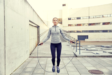 woman exercising with jump-rope outdoors