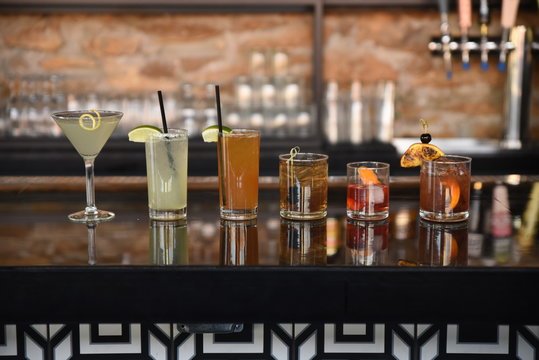 Row of various cocktails on counter