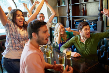 football fans or friends with beer at sport bar