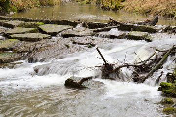 Small waterfall on a stone dam