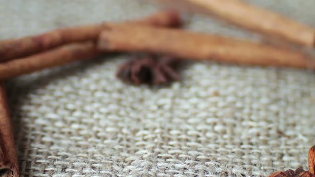 Cinnamon rods and star anise on the old cloth,A woman takes with her hands anise