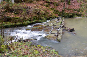 Small waterfall on a stone dam