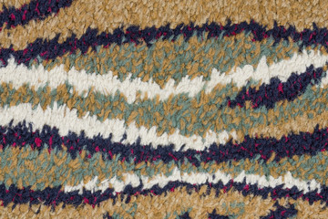 colorful texture with different colored horizontal stripes containing a mosaic of interwoven wool fibers zoom on full frame