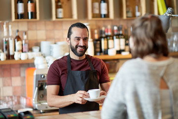 man or waiter serving customer in coffee shop