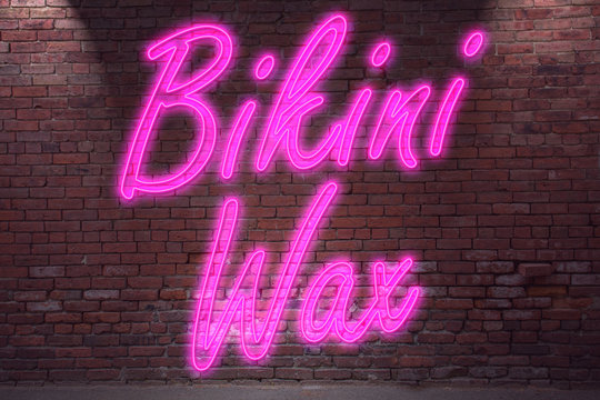 Leuchtreklame Bikini Wax an Ziegelsteinmauer