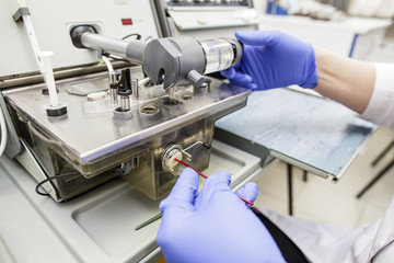 Fototapeta na wymiar A doctor in blue gloves processes medical blood tests for oxygen on measuring equipment