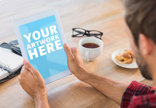 User with a Tablet in a Coffee Shop Mockup 2