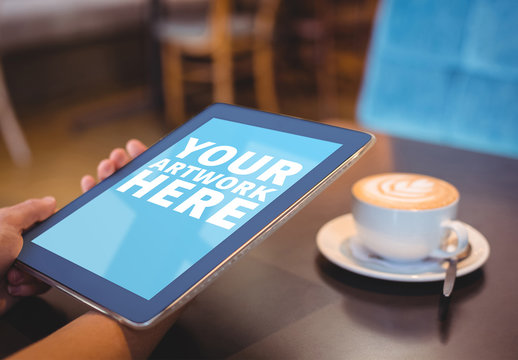 User with a Tablet in a Coffee Shop Mockup 3