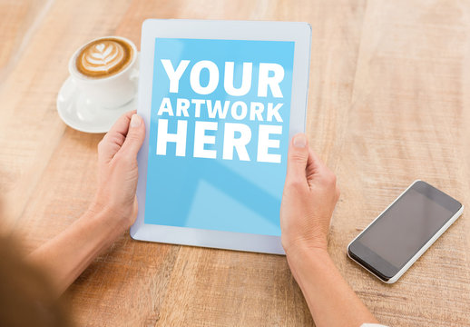 User with a Tablet in a Coffee Shop Mockup 4
