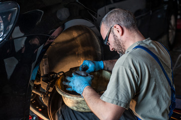 mechanic fixing a car at home