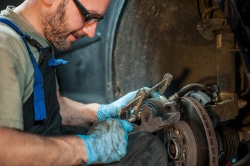 mechanic fixing a car at home