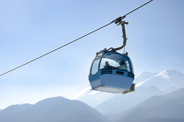 Fototapeta na wymiar Gondola lift and snowy mountains. Ski resort Bansko, Bulgaria, Pirin mountain