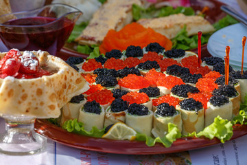 Pancakes - a festive meal on Shrove Tuesday. Pancakes with red caviar. A traditional dish of Slavic cuisine. Selective focus