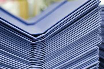 Many hard book covers stacked in a pile in offset pring production plant