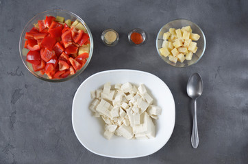 Typical Asian ingridients: pepper, tofu, mushrooms, onion and celery preparing in a cooker. Asian food.