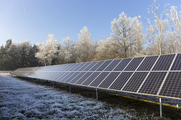 Solar Power Station in the snowy freeze winter Nature 