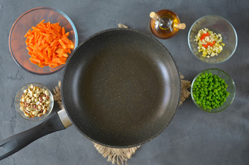 Stir Fry Ingredients ready to cook on the dark table with chopsticks, soy sauce and broth