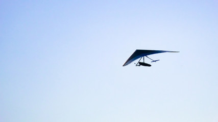 Glider silhouette flight over the clouds