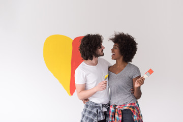 couple with painted heart on wall