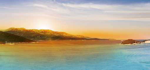 Fototapeta premium Panoramic Sunrise over the sea and famous Greek island Corfu, aerial shot