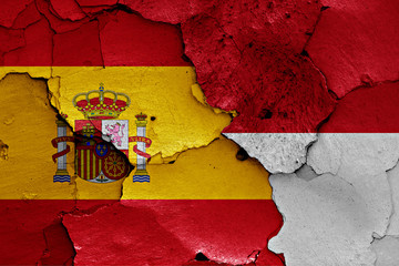 flags of Spain and Monaco painted on cracked wall