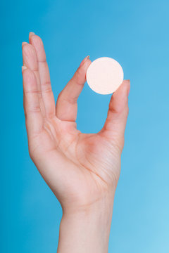 Woman hand holding big effervescent pill