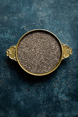 Chia seeds on dark baclground directly above copy space