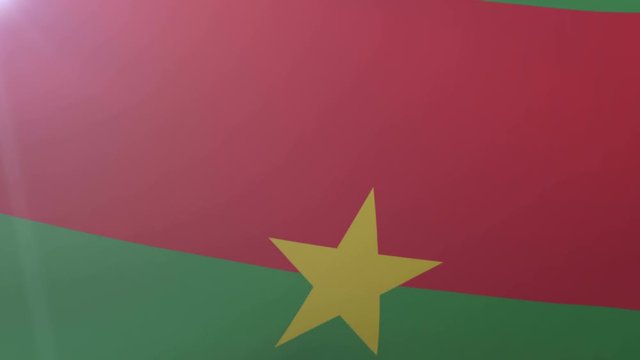 Flag of Burkina Faso waving on flagpole in the wind, national symbol of freedom