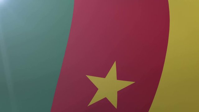 Flag of Cameroon waving on flagpole in the wind, national symbol of freedom