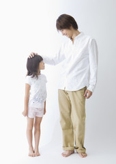 Father and daughter standing side by side