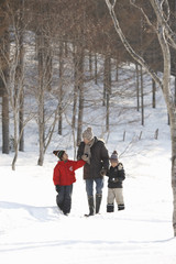 Fototapeta na wymiar Father and children taking a walk