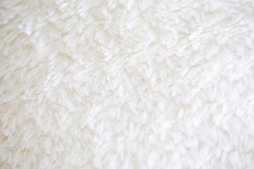 Smooth, soft and flurry white carpeting material texture.
