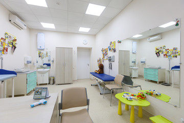 A pediatrician's office in a blue and white interior.