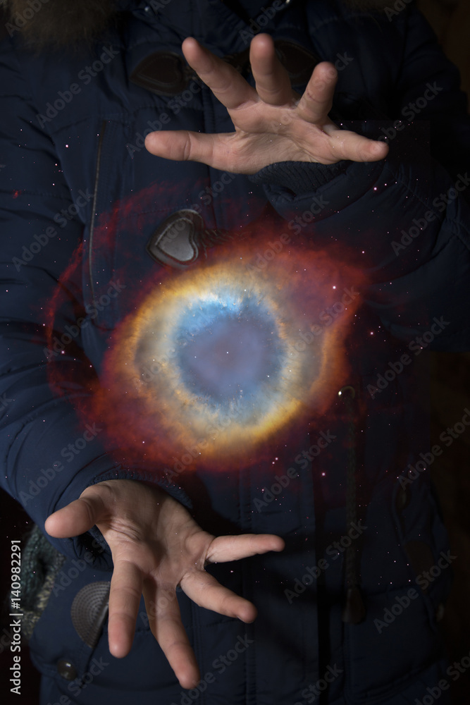 Wall mural The vast universe in the hands of a child. Elements of this image furnished by NASA.