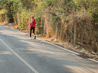 Obraz premium old fitness man running at forest trail