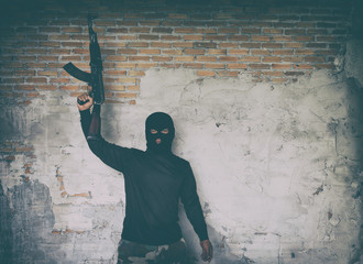 terrorist in black uniform and mask with kalashnikov